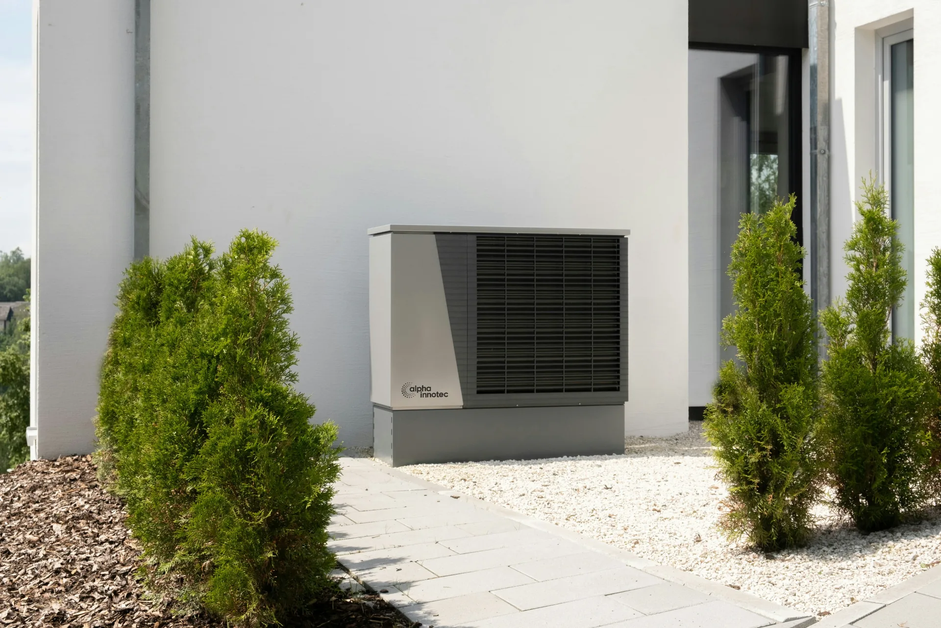 Residential heat pump unit installed on the exterior of a modern home, a key component for FortisBC rebate eligibility